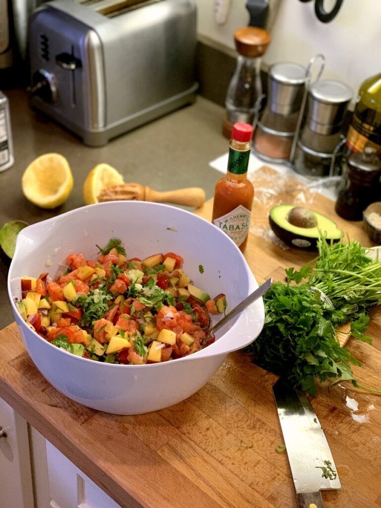 mixed ceviche with peach ingredients around